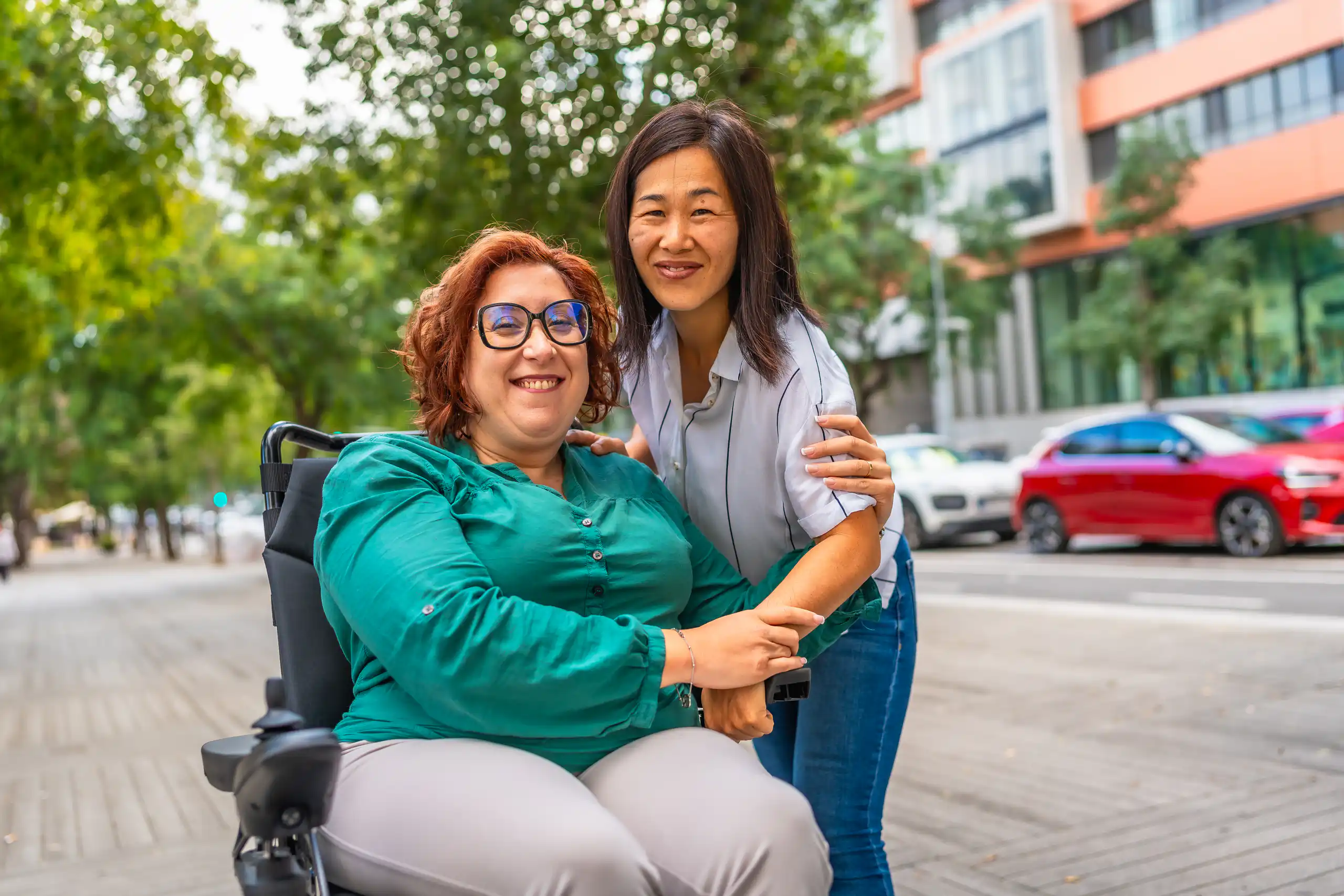 Two people smiling together on a street, illustrating disability support services in the lockyer valley.