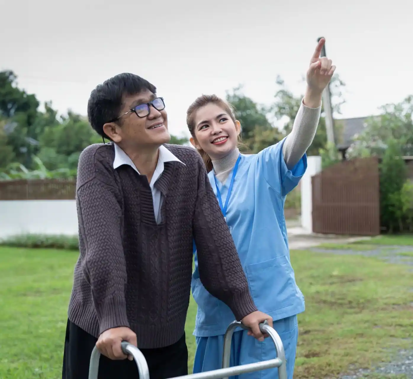 Two people looking towards the sky outdoors, illustrating community nursing.
