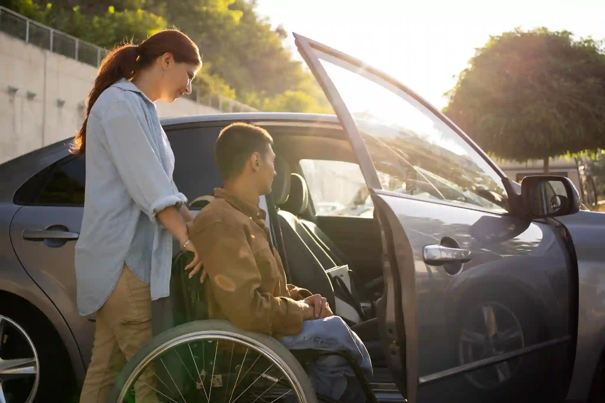 Two people beside an accessible vehicle