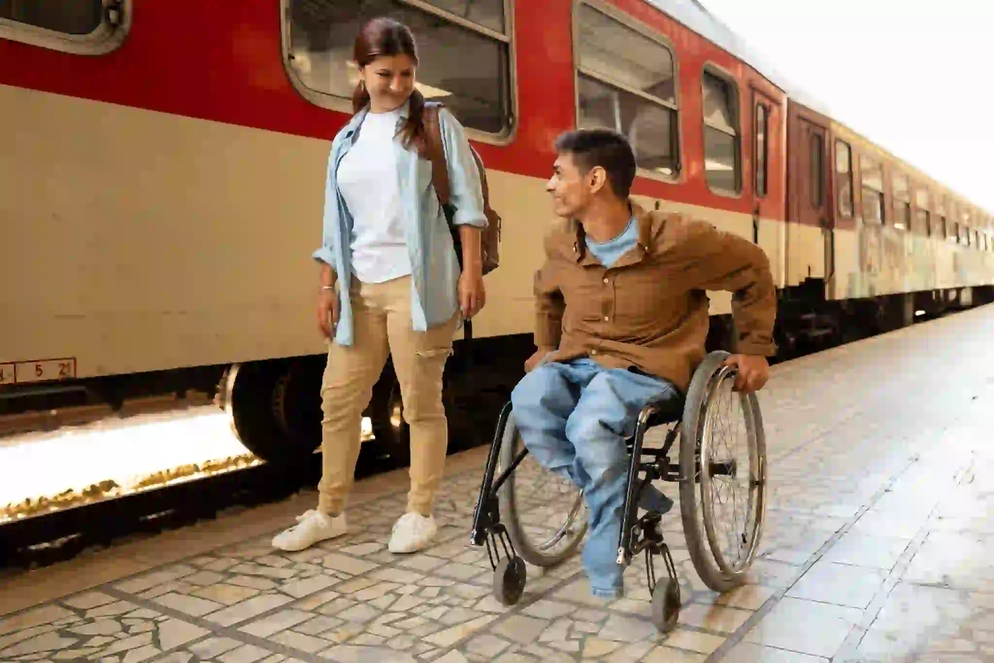 Two people waiting beside a train, illustrating community access support in moreton bay.