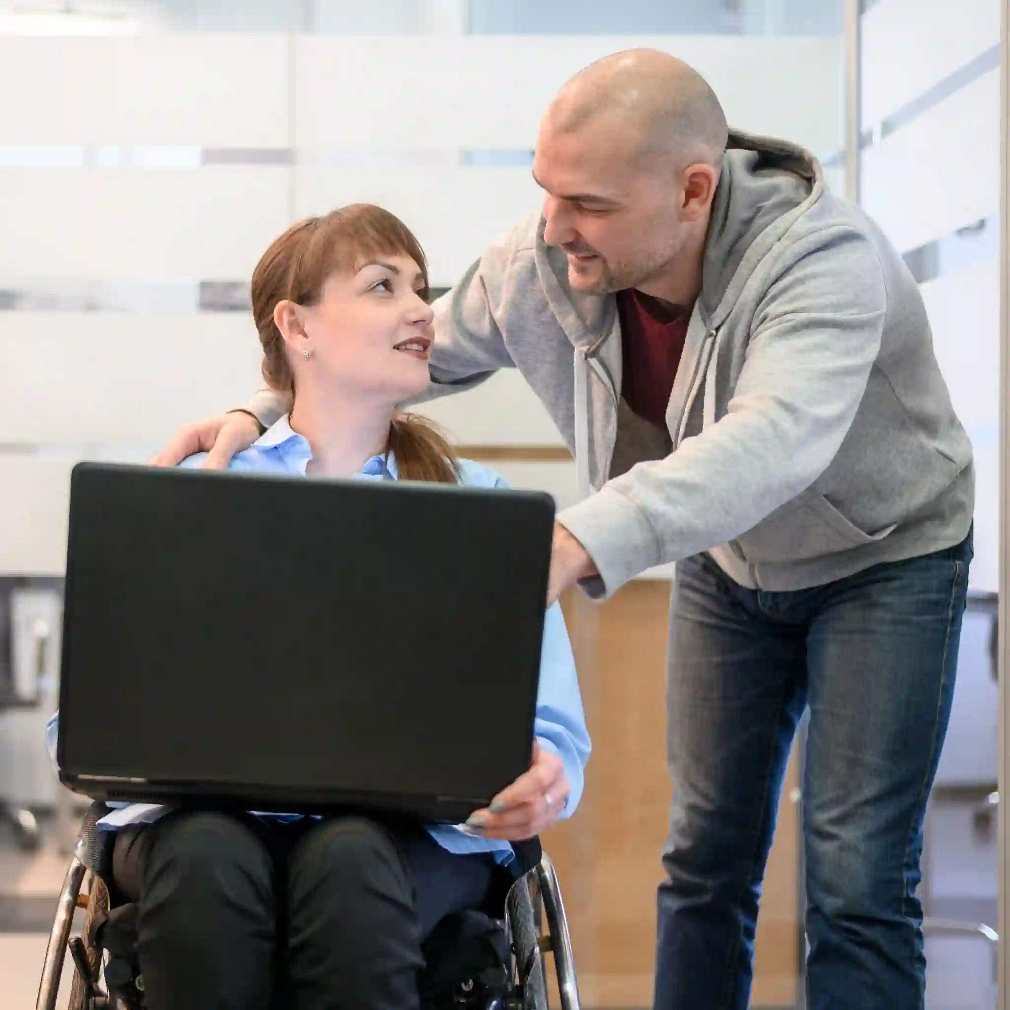 Two people working together at a computer, illustrating community access support in toowoomba.