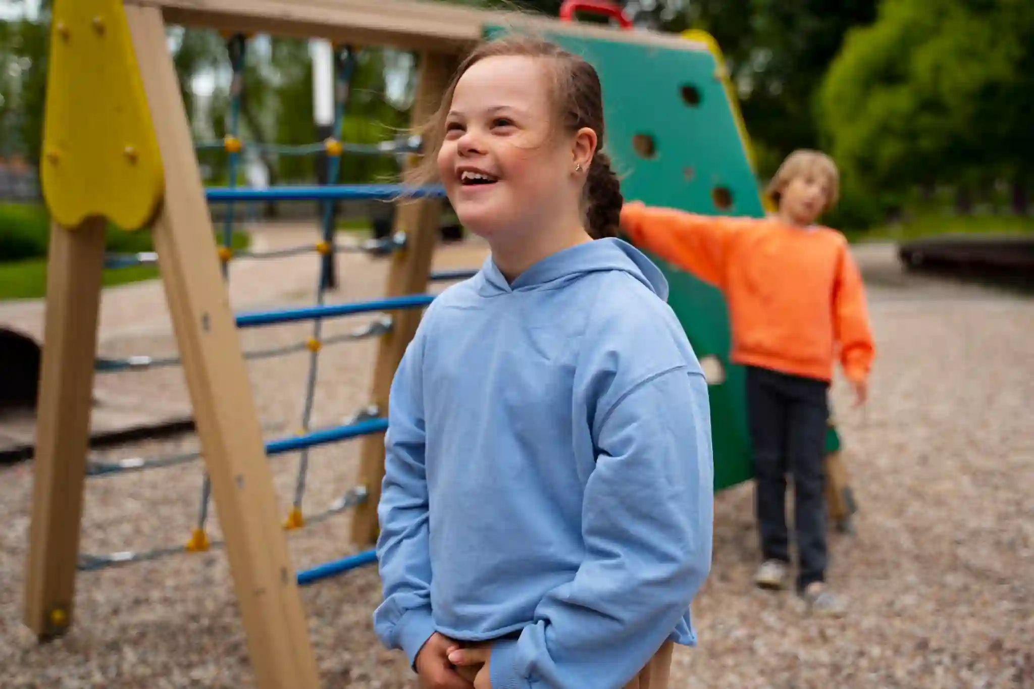 A child smiling while playing outdoors